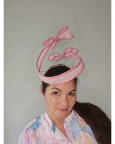 A picture of a Pink Bow Floating Headpiece by Melissa Rath Millinery