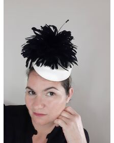 A picture of a black and white leather headpiece by Melissa Rath Millinery.