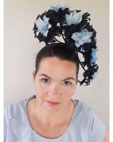 A picture of a blue floating feather headpiece by Melissa Rath Millinery listed on hatporium