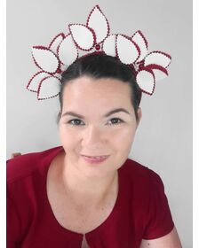 A picture of a red and white leather headband by Melissa  Rath Millinery