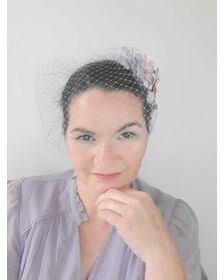 A picture of a rainbow veiled headband by Melissa Rath Millinery