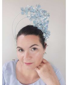 A picture of a blue pleather millinery halo crown by Melissa Rath Millinery