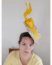 A picture of a floating boater hat in yellow by Melissa Rath Millinery listed on hatporium