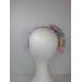 A picture of a rainbow veiled headband by Melissa Rath Millinery