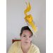 A picture of a floating boater hat in yellow by Melissa Rath Millinery listed on hatporium